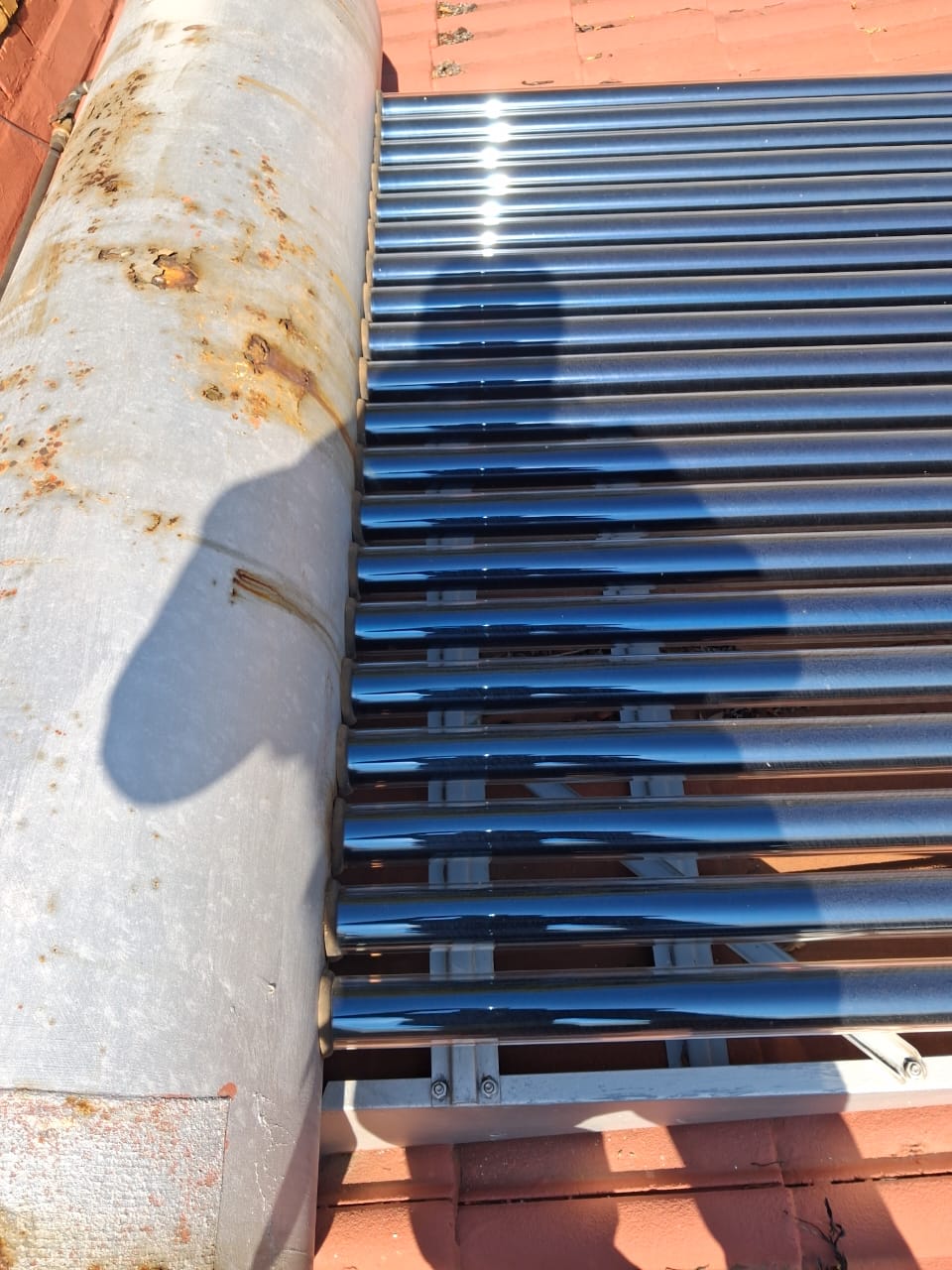 Solar evacuated-tube collector on a tiled roof