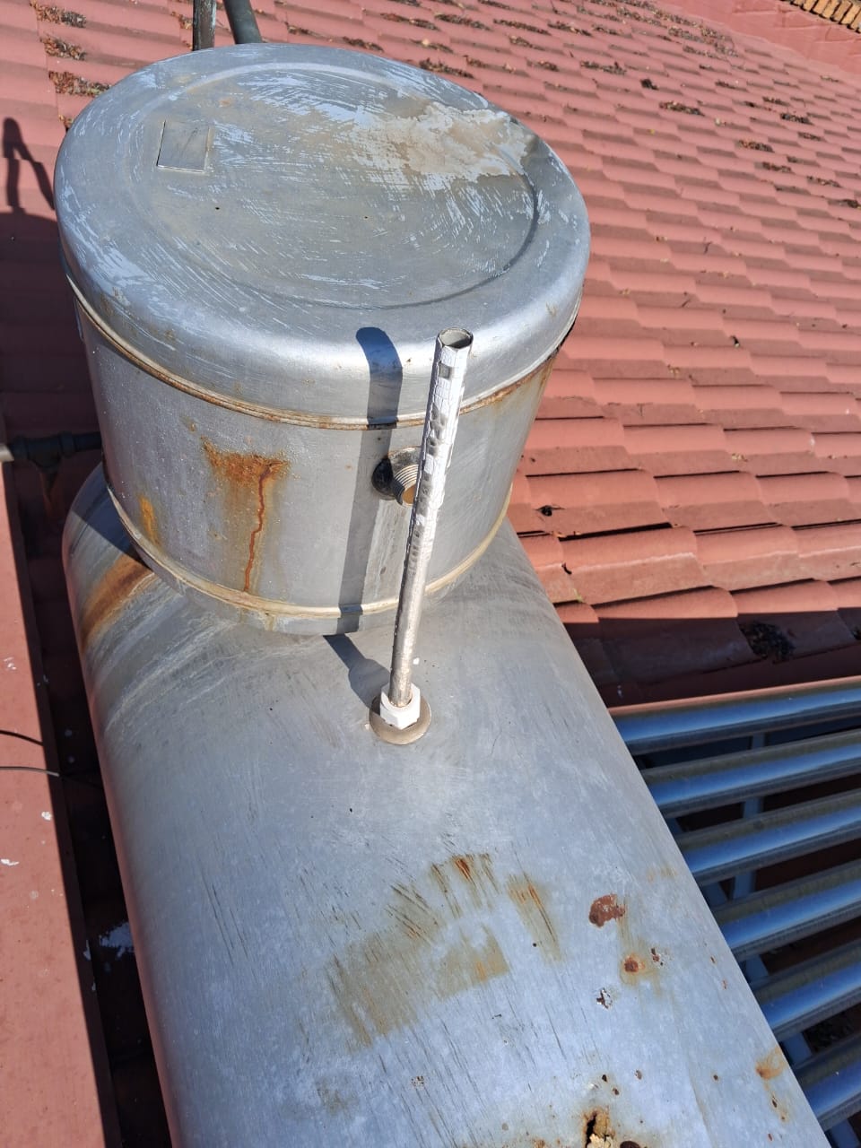 Solar geyser tank mounted on a tiled roof