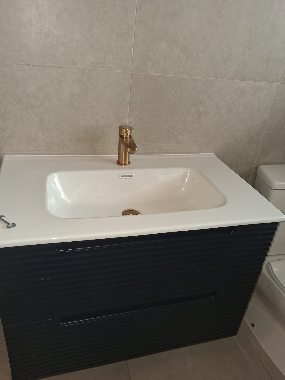 Navy fluted vanity with brushed-gold mixer tap